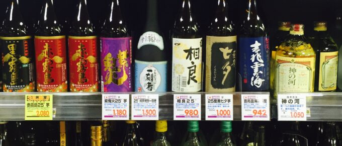 Bottles of shochu line the shelves at a supermarket.